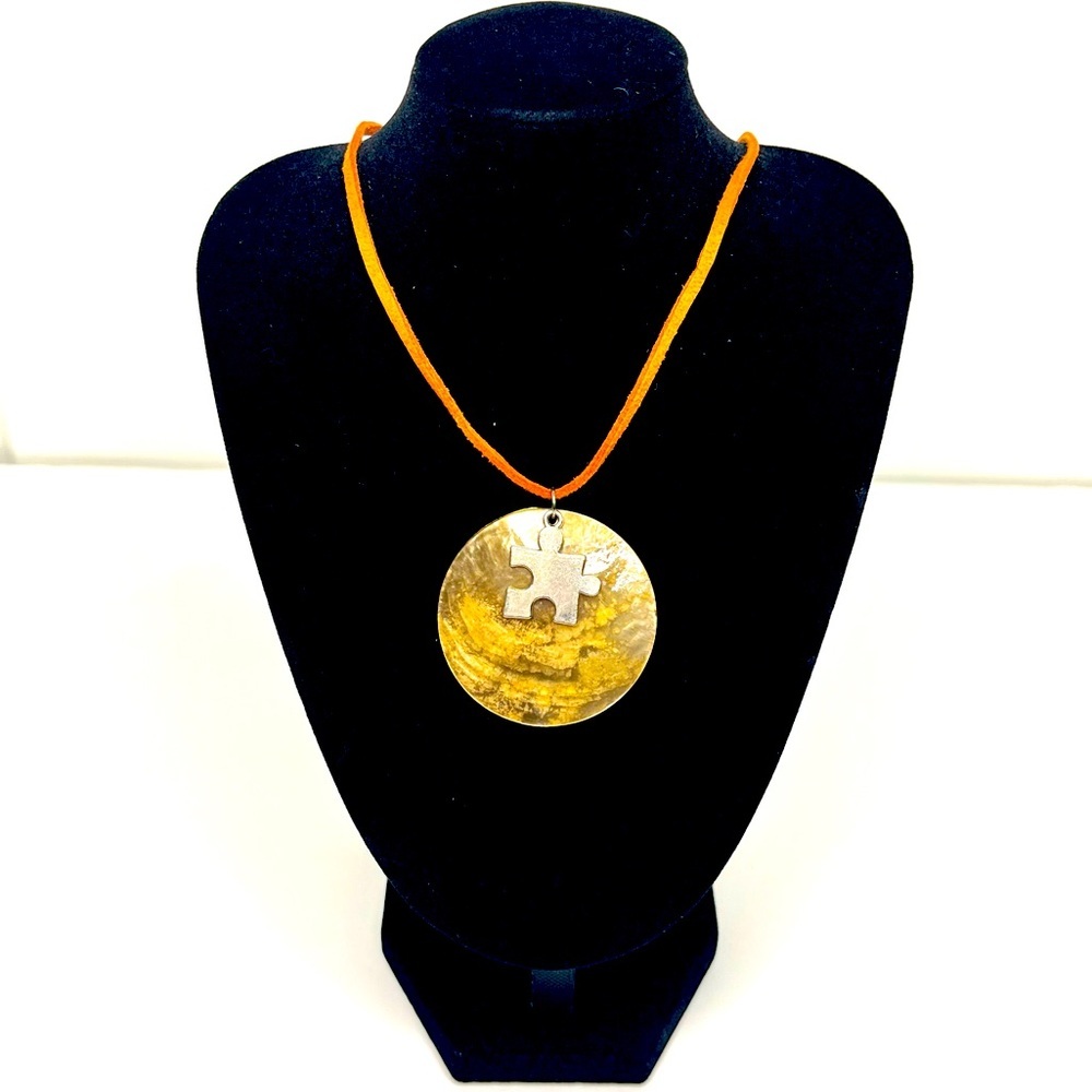 Shell Pendant Necklace Silver-Like Puzzle Piece Charm on an Orange Leather Cord